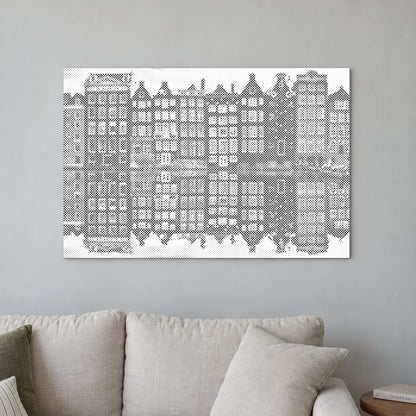 Prikmaleriet “Amsterdam huse”, på en lys væg i et rum med blødt dagslys.