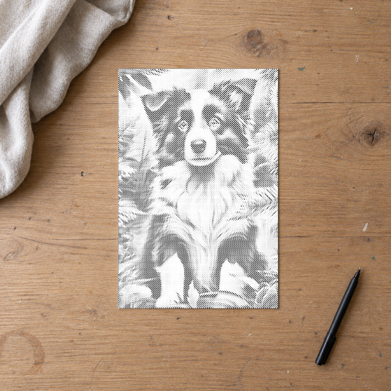 Prikmaleriet “Border Collie hvalp”, set ovenfra på et arbejdsbord i blødt dagslys.