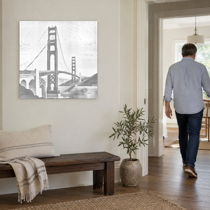 Prikmaleriet “Golden Gate Bridge”, på en lys væg med en person på vej gennem døren ved siden af.