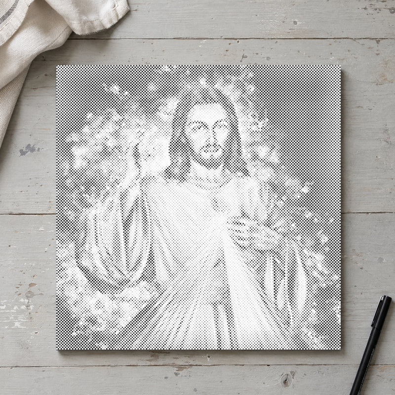 Prikmaleriet “Jesus: Fortsættelsen”, set ovenfra på et arbejdsbord i blødt dagslys.