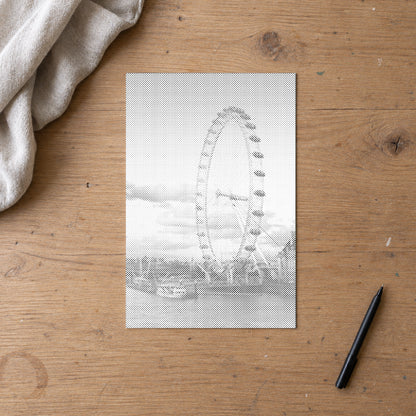 Prikmaleriet “London Eye”, set ovenfra på et arbejdsbord i blødt dagslys.